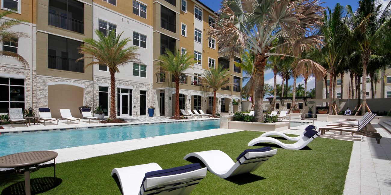 Bainbridge Coral Springs pool area with wavy loungers in fake grass