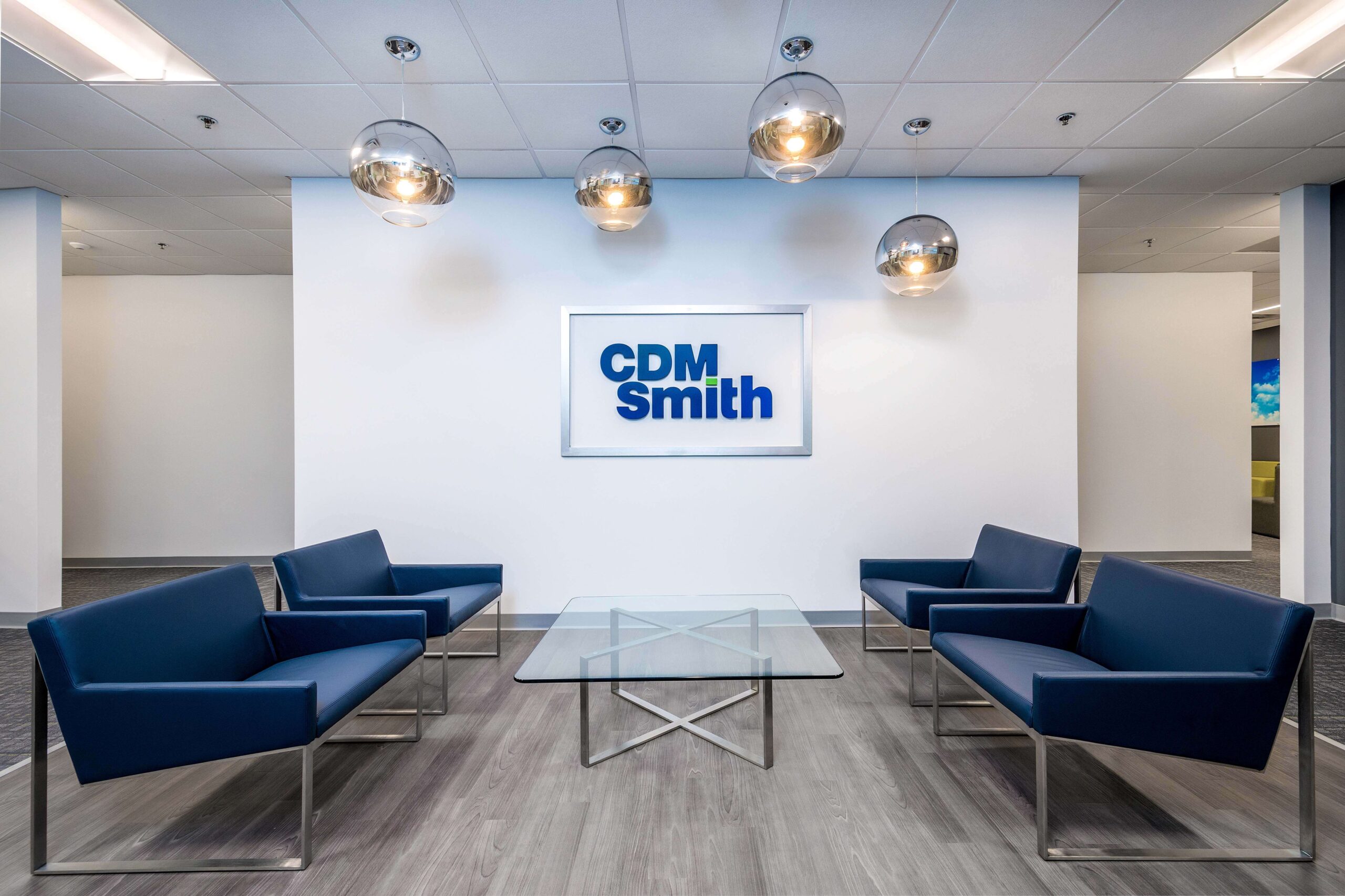 CDM Smith Office sitting area with couches facing each other and logo wall at the end
